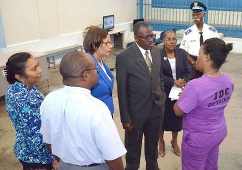 Photo: National Security Minister Brigadier Edmund Dillon (centre) speaks to a female detainee at the Immigration Detention Centre.