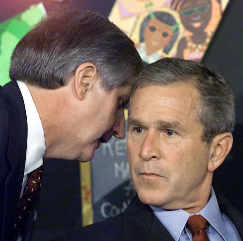 Photo: Then White House Chief of Staff Andy Card (left) tells US president George W Bush, in a Florida classroom, that terrorists have struck in New York City. (Copyright Slate.com)