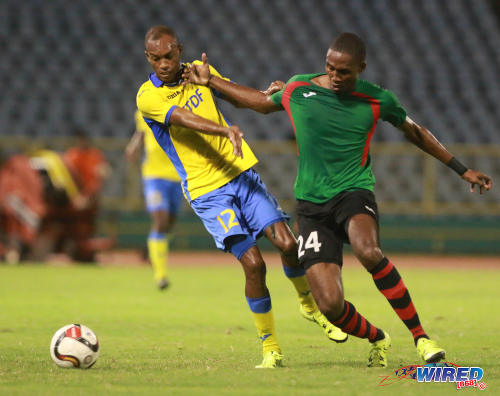 Photo: San Juan Jabloteh defender Adrian Reid (right) tries to hold off Defence Force winger Jemel Sebro during 2016 Pro Bowl semifinal action on May 13 at the Hasely Crawford Stadium on Port of Spain. (Courtesy Nicholas Bhajan/Wired868)