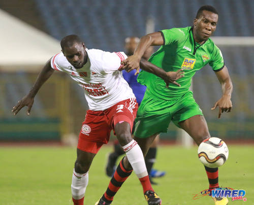 Photo: San Juan Jabloteh forward Jamal Gay (right) tries to force his way past Central FC defender Keion Goodridge during Pro League action on 17 May 2016 at the Hasely Crawford Stadium in Port of Spain. Gay scored twice as Jabloteh won 3-2. (Courtesy Nicholas Bhajan/Wired868)