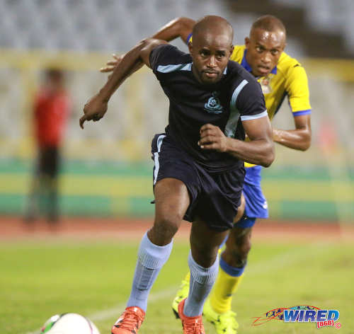 Photo: Police FC left back Dexter Alleyne tries to outrun Defence Force flanker Jemel Sebro during Pro League action at the Hasely Crawford Stadium on 3 May 2016. Defence Force won 3-2. (Courtesy Nicholas Bhajan/Wired868)