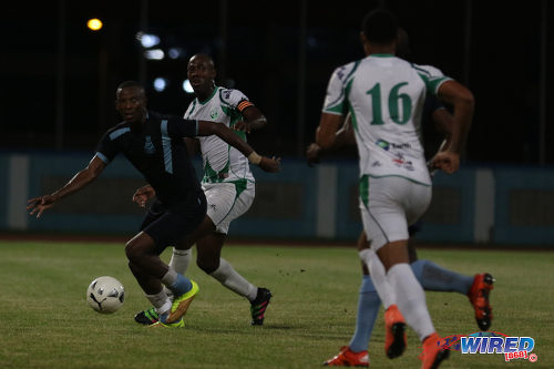 Photo: Police FC forward Jamal Perry (far left) keeps his eye on the ball while W Connection defender Daneil Cyrus (second from left) keeps an eye on him during Pro Bowl quarterfinal action at the Ato Boldon Stadium on 10 May 2016. Perry scored once but Connection won 4-3. (Courtesy Chevaughn Christopher/Wired868)