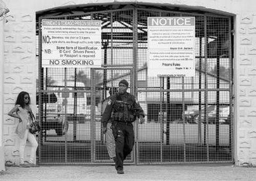 Photo: A police office leaves a Trinidad and Tobago prison. (Copyright Trinidad Guardian)