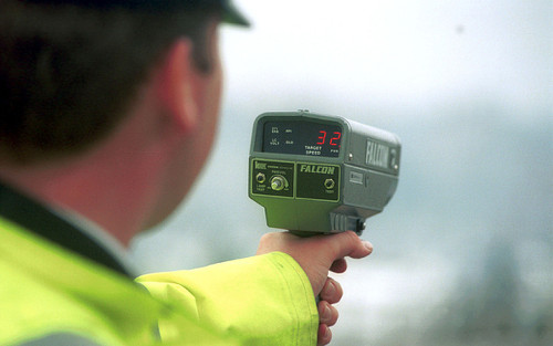 Photo: A British police officer uses a speed gun. (Copyright UK Telegraph)