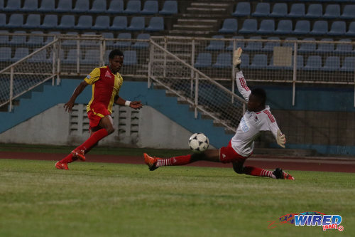 Photo: North East Stars winger Anthony Guppy (left) strokes the ball past Central FC goalkeeper Javon Sample during Pro Bowl quarterfinal action at the Ato Boldon Stadium on 10 May 2016. Stars won 2-1. (Courtesy Chevaughn Christopher/Wired868)