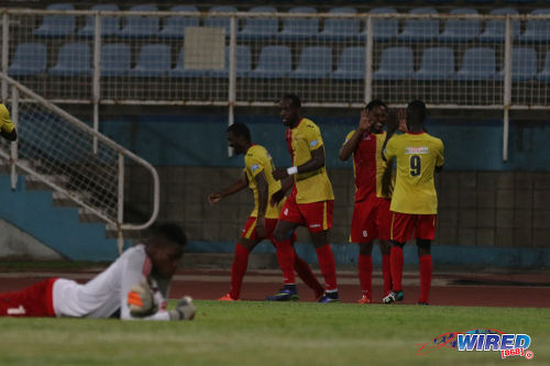 Photo: North East Stars players celebrate their opening goal from Anthony Guppy during their Pro Bowl quarterfinal round clash with Central FC at the Ato Boldon Stadium on 10 May 2016. Looking on is crestfallen Central FC goalkeeper Javon Sample (far left). (Courtesy Chevaughn Christopher/Wired868)