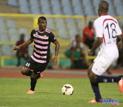 Photo: North East Stars poacher Kerry Baptiste (left) is on the prowl while Morvant Caledonia defender Joel Russell looks during Pro League action at the Hasely Crawford Stadium on 3 May 2016. Baptiste scored twice as Stars won 3-2. (Courtesy Nicholas Bhajan/Wired868)