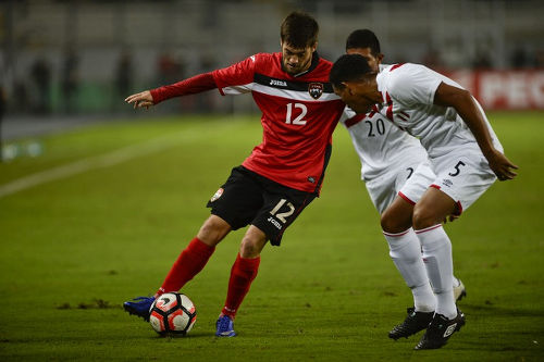 Photo: Trinidad and Tobago midfielder Sean De Silva (left) takes on Peru midfielder Adan Balbin during a friendly international match at the National stadium in Lima on 23 May 2016.  Peru won 4-0. (Copyright Ernesto Benavides/AFP 2016)