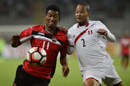 Photo: Trinidad and Tobago striker Willis Plaza (left) tries to keep the ball from Peru defender Alberto Rodriguez during international friendly action at the National stadium in Lima on 23 May 2016. (Copyright Ernesto Benavides/AFP 2016/Wired868)