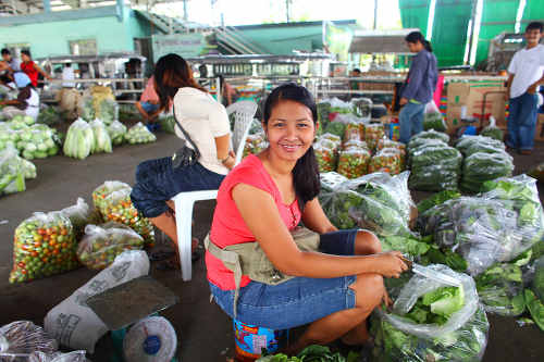 Photo: A young woman sells at the market.