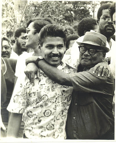 Photo: Raffique Shah (left) is greeted by his late father, Haniff Shah, on his release from prison on 27 July 1972. (Courtesy Raffique Shah)