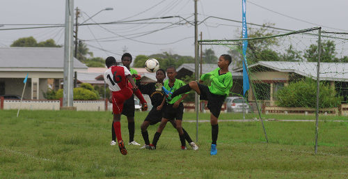 Photo: Action between San Juan Jabloteh (red and white shirts) and La Horquetta XF in the Republic Bank National Youth League Under-12 division on 11 June 2016. (Courtesy Chevaughn Christopher/All Sport)