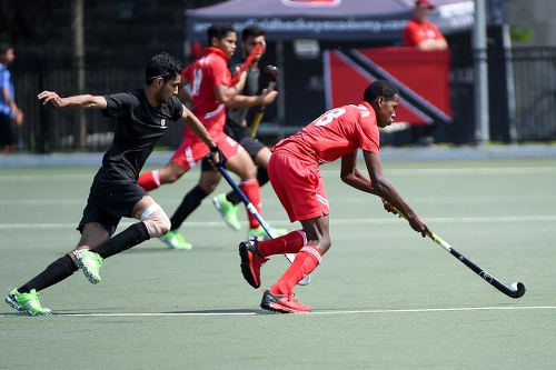 Photo: Trinidad and Tobago's Teague Marcano (right) in action at the Toronto 2016 Pan American Men's Junior Hockey Championships.