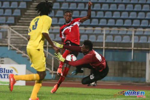 Photo: Trinidad and Tobago National Under-20 attacker Isaiah Hudson (centre) is denied by St Lucia goalkeeper Noah Didier during 2016 Caribbean Cup qualifying action at the Ato Boldon Stadium on 19 June 2016. The two teams played to a 1-1 draw. (Courtesy Chevaughn Christopher/Wired868)