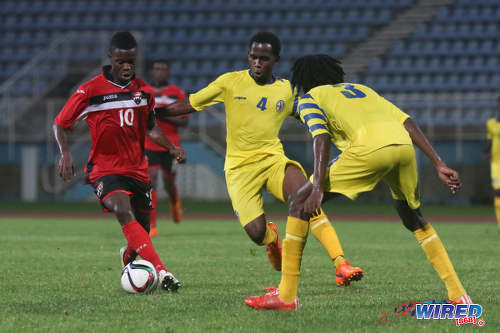 Photo: Trinidad and Tobago National Under-20 captain Jabari Mitchell (left) tries to keep the ball away from St Lucia midfielder Zachernus Simon during 2016 Caribbean Cup qualifying action at the Ato Boldon Stadium on 19 June 2016. The two teams played to a 1-1 draw. (Courtesy Chevaughn Christopher/Wired868)