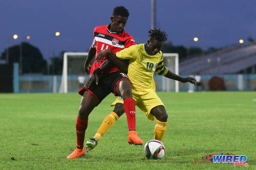 Photo: Trinidad and Tobago National Under-20 midfielder Kadeem Riley (left) tries to win the ball from St Lucia playmaker Cassius Joseph during 2016 Caribbean Cup qualifying action at the Ato Boldon Stadium on 19 June 2016. The two teams played to a 1-1 draw. (Courtesy Chevaughn Christopher/Wired868)