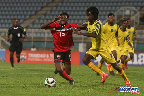 Photo: Trinidad and Tobago National Under-20 winger Kathon St Hillaire (left) is closed down by St Lucia left back Keeroy Lionel during 2016 Caribbean Cup qualifying action at the Ato Boldon Stadium on 19 June 2016. The two teams played to a 1-1 draw. (Courtesy Chevaughn Christopher/Wired868)