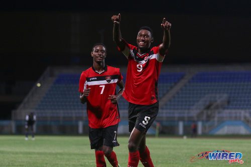 Photo: Trinidad and Tobago striker Nicholas Dillon (right) celebrates one of his six goals against Turks and Caicos alongside teammate Isaiah Hudson during Caribbean Cup qualifying action at the Ato Boldon Stadium on 17 June 2016. T&T won 11-0. (Courtesy Chevaughn Christopher/Wired868)