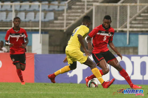 Photo: Trinidad and Tobago National Under-20 striker Nicholas Dillon (right) takes on St Lucia defender Melvin Doxilly during 2016 Caribbean Cup qualifying action at the Ato Boldon Stadium on 19 June 2016. The two teams played to a 1-1 draw. (Courtesy Chevaughn Christopher/Wired868)