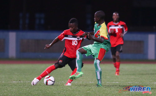 Photo: Trinidad and Tobago National Under-20 captain Jabari Mitchell (left) tries to work the ball past a Guadeloupe opponent during Caribbean Under-20 Cup qualifiers at the Ato Boldon Stadium in Couva on 15 June 2016. T&T won 1-0. (Courtesy Chevaughn Christopher/Wired868)