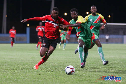 Photo: Trinidad and Tobago National Under-20 forward Nicholas Dillon (left) tries to power past Guadeloupe defender Hanane Nebot (centre) while his teammate Loic Nuiro looks on during Caribbean Under-20 Cup qualifiers at the Ato Boldon Stadium in Couva on 15 June 2016. T&T won 1-0. (Courtesy Chevaughn Christopher/Wired868)