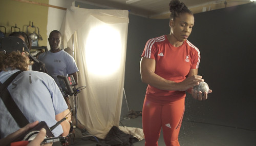 Photo: Cleopatra Borel (right) prepares for a TSTT photo shoot during a pre-2016 Olympic Games sponsorship engagement. (Copyright TSTT)