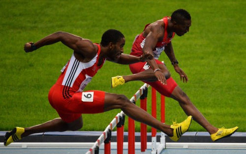 Photo: Trinidad and Tobago’s Jehue Gordon (left) and United States’ Michael Tinsley race to the line during the men’s 400 metres hurdles final at the Moscow 2013 IAAF World Championships at the Luzhniki Stadium on 15 August 2013. (Copyright AFP 2016/Antonin Thuillier)