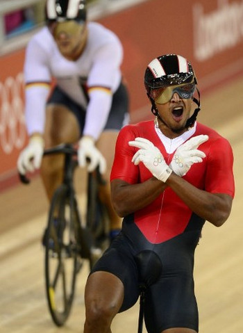 Photo: Njisane Nicholas Phillip celebrates after defeating Germany's Robert Forstemann during the London 2012 Olympic Games men's sprint round at the Velodrome in the Olympic Park in East London on 4 August 2012. (Copyright AFP 2016/Leon Neal)