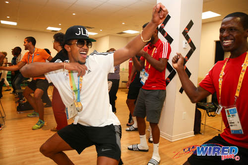 Photo: Trinidad and Tobago cycling star Njisane Phillip (centre) enjoys himself at an exercise event for senior citizens during the 2015 Pan American Games. (Courtesy Allan V Crane/Wired868)