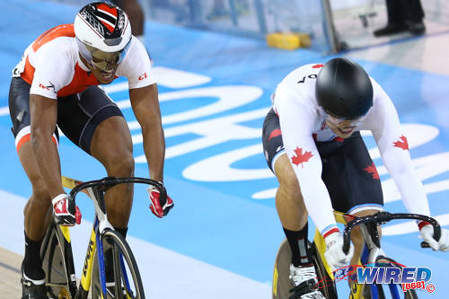 Photo: Trinidad and Tobago cyclist Njisane Phillip (right) chases Canada rider Hugo Barrett during the Toronto 2015 Pan American Games. (Courtesy Allan V Crane/CA Images/Wired868)