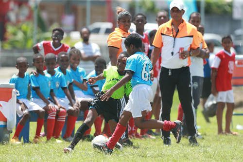 Photo: La Horquetta SA attacker Aydan Williams (left) takes on a Trincity Nationals opponent during Republic Bank National Youth League action on 4 June 2016. Williams scored the equaliser as the teams played to a 1-1 draw. (Courtesy Allan V Crane/CAI Sports/All Sport)