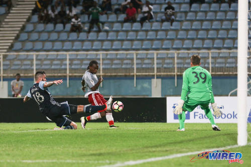 Photo: Vancouver Whitecaps defender David Edgar (left) cuts out an effort by Central FC midfielder Darren Mitchell (centre) while goalkeeper Spencer Richey looks on during CONCACAF Champions League action in Couva on 2 August 2016. Vancouver won 1-0. (Courtesy Chevaughn Christopher/Wired868)