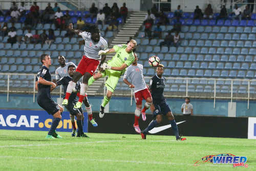 Photo: Central FC forward Kenwyne Jones (centre) heads a free kick past Sporting Kansas City goalkeeper Jon Kempin during CONCACAF Champions League action at the Ato Boldon Stadium in Couva on 16 August 2016. However, the effort was controversially ruled out by the match referee. Jones did score in the match, which ended 2-2. (Courtesy Chevaughn Christopher/Wired868)