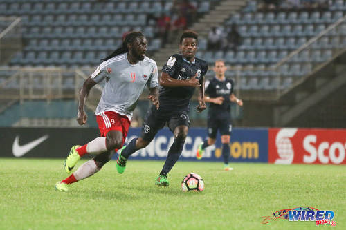 Photo: Central FC star forward Kenwyne Jones (left) tries to motor past Sporting Kansas City midfielder Soni Mustivar during CONCACAF Champions League action at the Ato Boldon Stadium in Couva on 16 August 2016. Both teams played to a 2-2 draw. (Courtesy Chevaughn Christopher/Wired868)