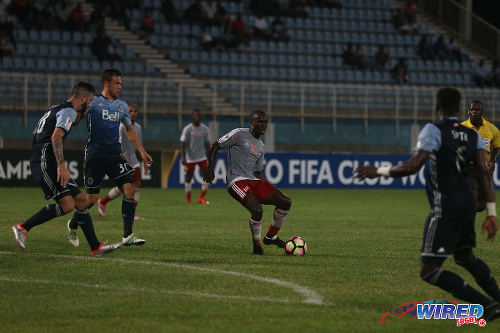 Photo: Central FC midfielder Keron Cummings (centre) passes the ball during CONCACAF Champions League action in Couva on 2 August 2016. Cummings made his competitive outing against Vancouver, after being shot in his leg on 27 December 2015. (Courtesy Chevaughn Christopher/Wired868)