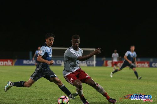 Photo: Central FC left back Kevon Villaroel (right) eludes Vancouver Whitecaps midfielder Nicholas Mezquida during CONCACAF Champions League action in Couva on 2 August 2016. (Courtesy Chevaughn Christopher/Wired868)