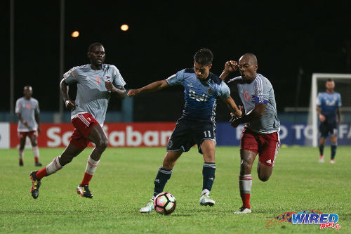 Photo: Central FC captain and midfielder Leston Paul (right) keeps tabs on Vancouver Whitecaps attacker Nicholas Mezquida (centre) while defender Keion Goodridge looks on during CONCACAF Champions League action in Couva on 2 August 2016. (Courtesy Chevaughn Christopher/Wired868)