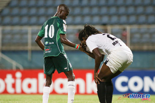 Photo: W Connection attacker Dimitrie Apai (left) gives Honduras Progreso defender Roy Smith a hand during CONCACAF Champions League action at the Ato Boldon Stadium, Couva on 25 August 2016. Connection and Progreso played to a 1-1 draw. (Courtesy Chevaughn Christopher/Wired868)