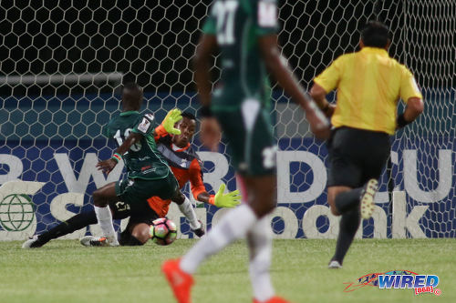 Photo: W Connection attacker Dimitrie Apai (left) is blocked by Honduras Progreso goalkeeper Woodrow West during CONCACAF Champions League action at the Ato Boldon Stadium, Couva on 25 August 2016. Connection and Progreso played to a 1-1 draw. (Courtesy Chevaughn Christopher/Wired868)