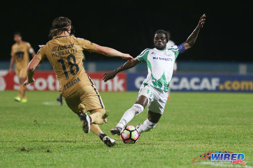 Photo: W Connection captain Hughtun Hector (right) tries to elude Pumas UNAM opponent Jose Garcia during CONCACAF Champions League action in Couva on 3 August 2016. Pumas won 4-2. (Courtesy Chevaughn Christopher/Wired868)