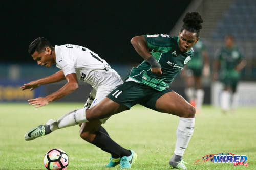 Photo: W Connection attacker Neil Benjamin Jr (right) challenges Honduras Progreso defender Nixon Duarte for the ball during CONCACAF Champions League action at the Ato Boldon Stadium, Couva on 25 August 2016. Connection and Progreso played to a 1-1 draw. (Courtesy Chevaughn Christopher/Wired868)