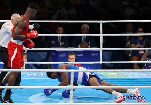 Photo: Trinidad and Tobago boxer Nigel Paul (right) looks for the light switch during his super heavyweight clash with Nigeria's Efe Ajagba in Rio 2016 Olympic competition on 13 August 2016. (Courtesy Sean Morrison/Wired868)