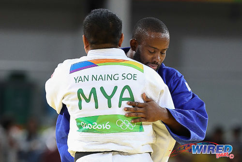 Photo: Trinidad and Tobago's Christopher George (background) congratulates Myanmar’s Naing Soe Yan after their judo contest at the Rio 2016 Olympic Games on 11 August. (Courtesy Sean Morrison/Wired868)