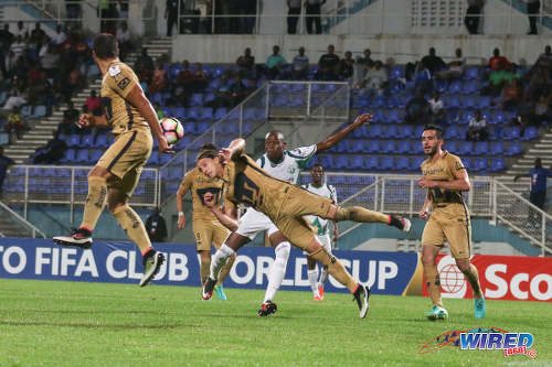 Photo: Pumas UNAM player Jose Antonio Garcia (centre) heads clear from W Connection attacker Jamal Charles during CONCACAF Champions League action in Couva on 3 August 2016. Pumas won 4-2. (Courtesy Chevaughn Christopher/Wired868)