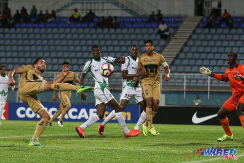 Photo: A Pumas UNAM attacker (left) fires towards goal while his teammate Eduardo Herrera (centre) and W Connection players (from left) Kurt Frederick, Jelani Peters and Julani Archibald look on during CONCACAF Champions League action in Couva on 3 August 2016. Pumas won 4-2. (Courtesy Chevaughn Christopher/Wired868)