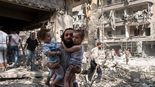 Photo: A family run for cover during a bombing in Syria. (Copyright Nehandradio.com)