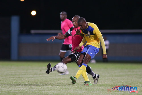 Photo: Defence Force playmaker Hashim Arcia (right) has his effort blocked by Central FC captain Leston Paul during the Digicel Charity Shield on 10 September 2016. Central won 3-1 from kicks from the penalty mark after a 2-2 regulation time draw. (Courtesy Chevaughn Christopher/Wired868)