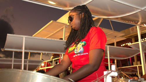 Photo: A female pannist from the birdsong Steel Academy plays Pan Magic, arranged by Andy Narell, at the 2015 Panorama Semifinals. (Copyright John Schmidt/SeeTobago.org)