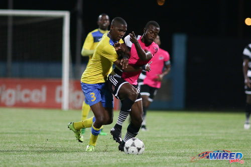 Photo: Central FC attacker Marcus Joseph (right) tries to hold off Defence Force defender Jamali Garcia during the Digicel Charity Shield on 10 September 2016. Garcia and Joseph are both capped by Trinidad and Tobago National Senior Team coach Stephen Hart. (Courtesy Chevaughn Christopher/Wired868)