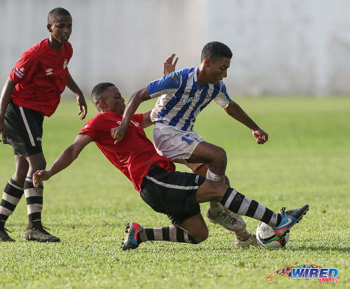 Photo: St Mary's College attacker Justin Brooks (right) tries to hurdle a tackle during SSFL Premier Division action against Pleasantville Secondary at Serpentine Road on 10 September 2016. (Courtesy Sean Morrison/Wired868)